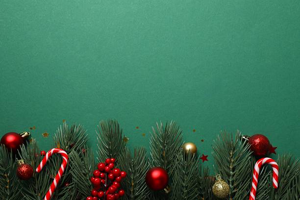 istock Christmas ornaments and pine branches on a green background. Flat lay, top view 2246393340