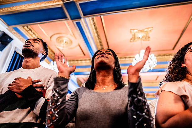 A deeply emotional moment of religious worship, capturing a woman in a state of spiritual intensity with her head tilted back and arms raised, surrounded by the ornate interior of a church.