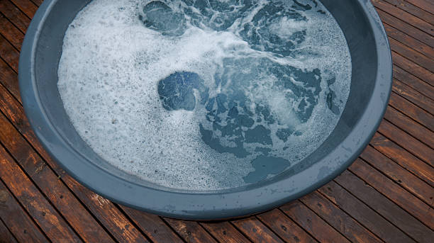 istock Bubbling water in a round tub on a wooden deck 2246394730