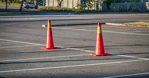 istock Two bright traffic cones in parking area.. 2246394909