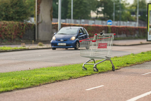 istock Shopping cart left abandoned on roadside grass.. 2246395348