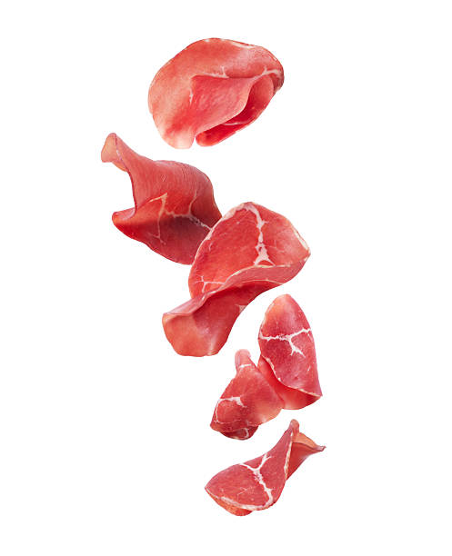 istock Slices of fresh prosciutto ham isolated on white background 2246396821