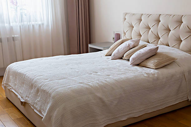 istock Cozy bedroom with elegant headboard and soft bedding creating serene atmosphere 2246398053