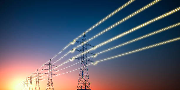 istock Electricity transmission towers with glowing wires 2246400248