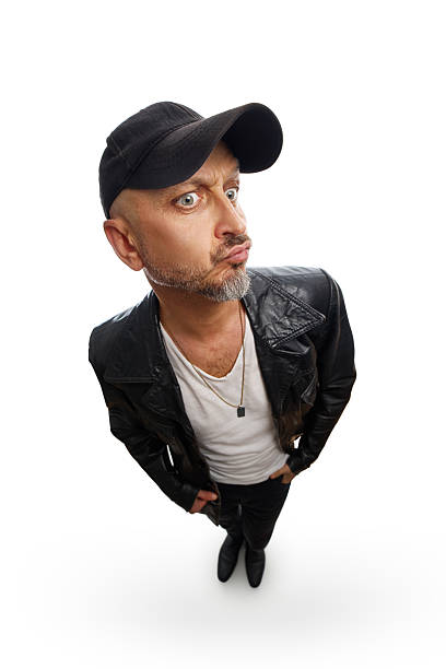 Man with his hands in his pockets and his lips pursed in surprise, captured from a high angle with a fisheye lens