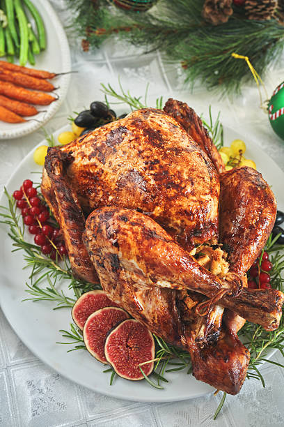 istock Having Stuffed Turkey for Christmas Holiday Dinner with Vegetables and Mashed Potatoes 2246401669