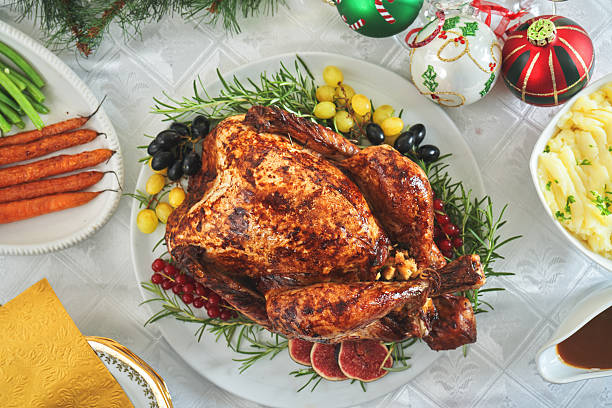 istock Having Stuffed Turkey for Christmas Holiday Dinner with Vegetables and Mashed Potatoes 2246401688