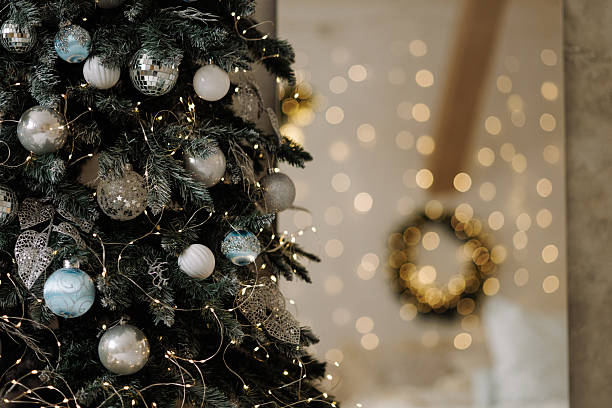 istock Cozy bedroom with Christmas wreath and blurred decorated tree with warm lights 2246404816