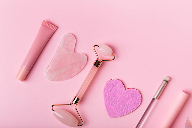 istock Stone roller facial massager and decorative cosmetics on pink background. 2246404948