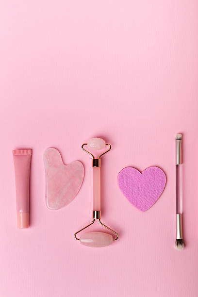 istock Stone roller facial massager and decorative cosmetics on pink background. 2246405467