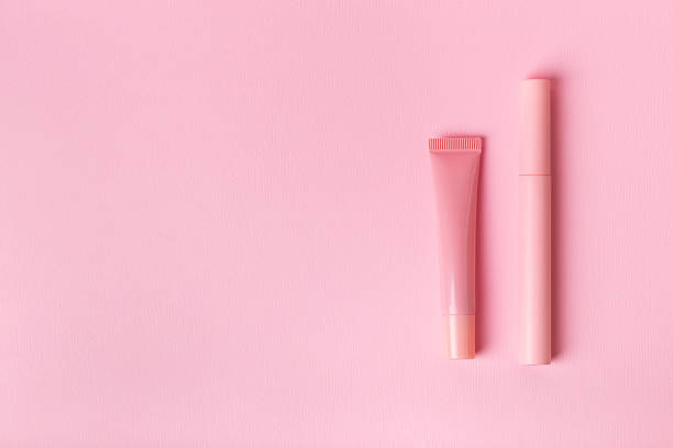 istock Mascara and lip gloss on pink background. 2246405793