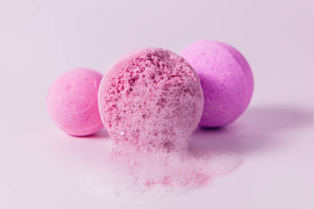 istock Colorful bath bombs melting softly on a light background 2246407952