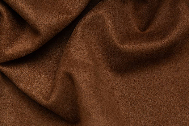 istock Soft brown textile fabric folded with gentle curves and smooth texture 2246407992