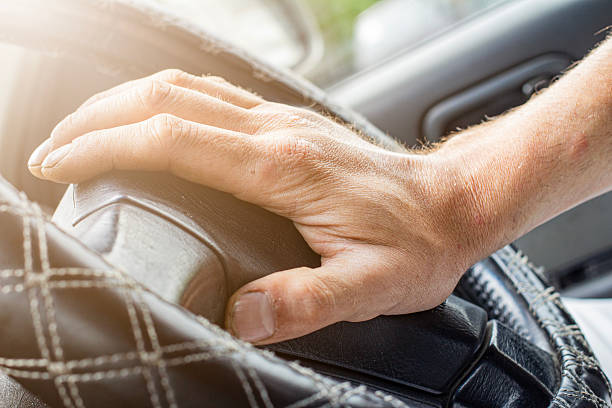 istock Angry driver is honking with a steering wheel. Concept of road aggression. Traffic jam. Hate being late 2246412932