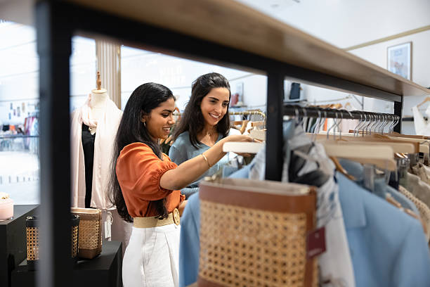 istock Happy young diverse retail store colleagues arranging merchandise 2246413192