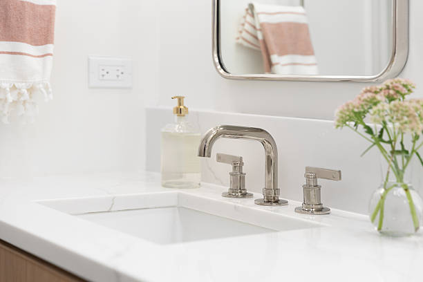istock A bathroom faucet detail with decorations on a white countertop. 2246418728