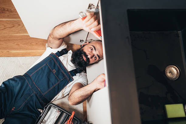istock Professional plumber repairing kitchen sink 2246419512