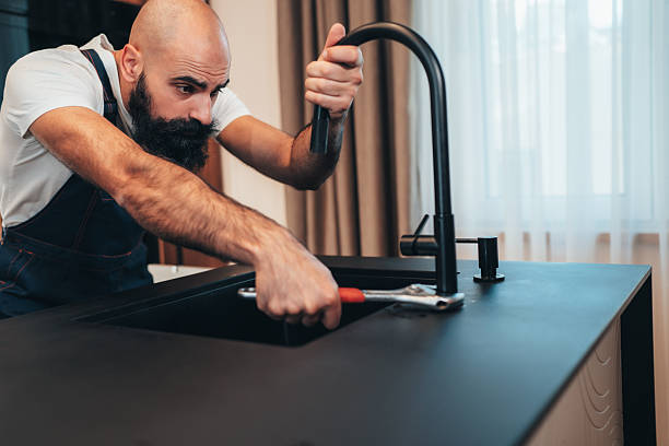 istock Professional plumber repairing kitchen sink 2246419522