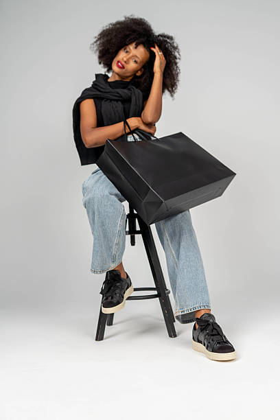 woman posing with shopping bag in studio