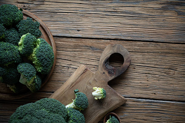 istock Fresh broccoli arranged on rustic wooden boards. 2246420374