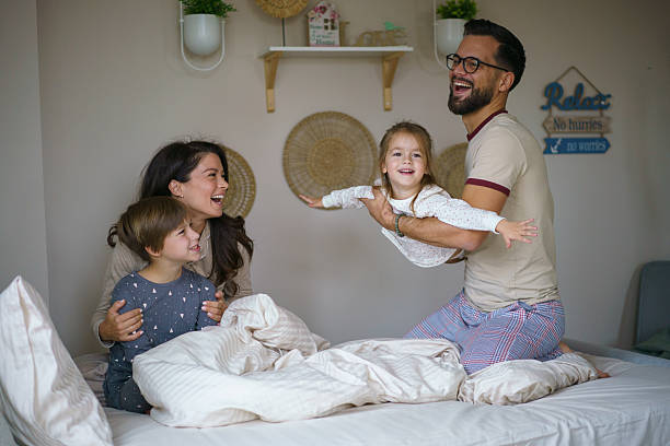istock Family playing laughing having fun in bed morning 2246421941
