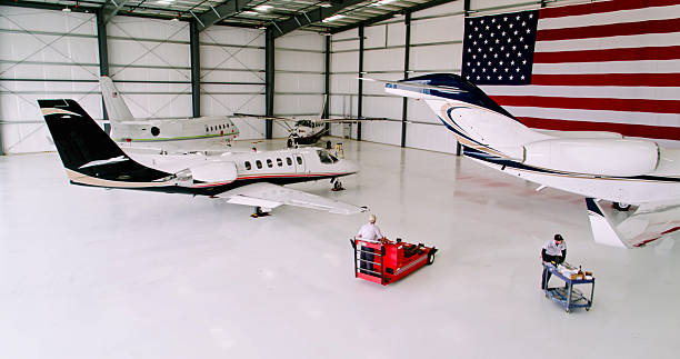 Drone shot of a private business jet inside of a brightly lit hangar at a small general aviation airport in California. This drone shot was taken with full permission and co-operation of the airport staff and the pilots of the aircraft.