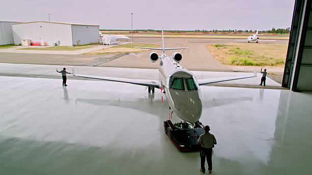 Front view of airplane on ground waiting to be boarded. Plane at airport on sunny day.