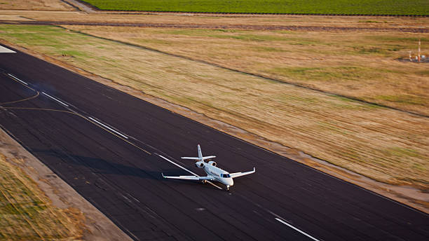 istock Small Airport Runway and Private Jet on Runway Before Takeoff 2246422402