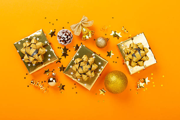 istock Golden gift boxes and decor on color background, top view 2246426991