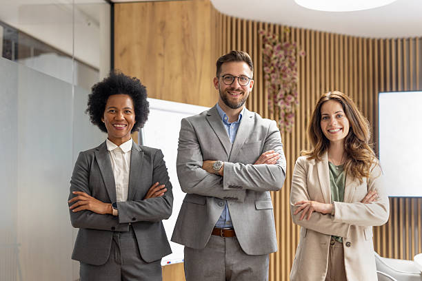 istock Confident business team smiling with arms crossed in office 2246428894
