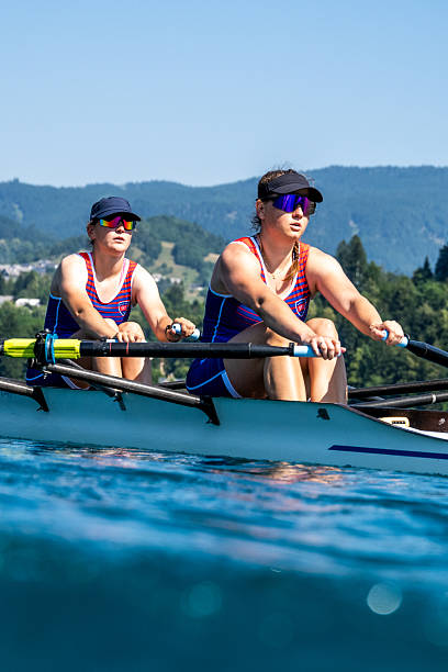 istock Medium Shot of Two Women Focused on Rowing Double Scull 2246429015