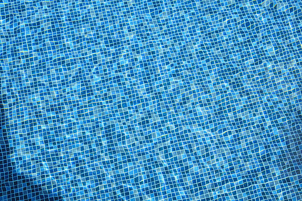 istock Swimming pool with blue crystal clear water surface and ripple wave background 2246429220