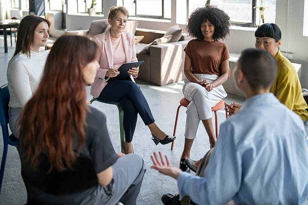istock Businesswomen sitting in circle having a meeting discussing work 2246430682