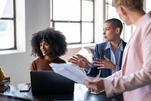 istock Businesswomen collaborating on project in modern office 2246430688