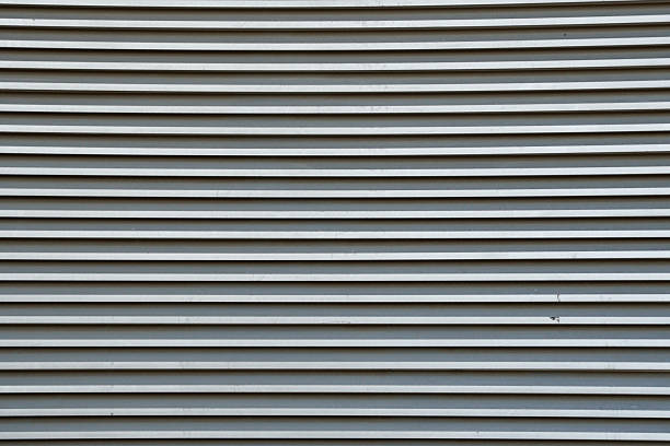 istock Close-up view of metal slatted shutter with parallel lines 2246433162