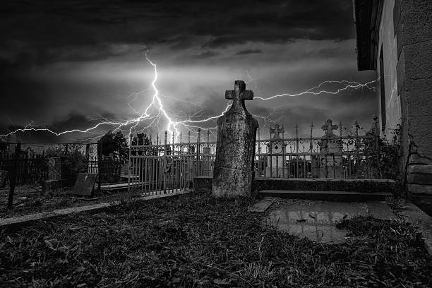 Spooky dark cemetery on the stormy winter day.