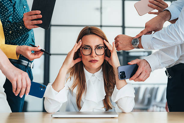 istock Overwhelmed Businesswoman in a Busy Environment 2246434877