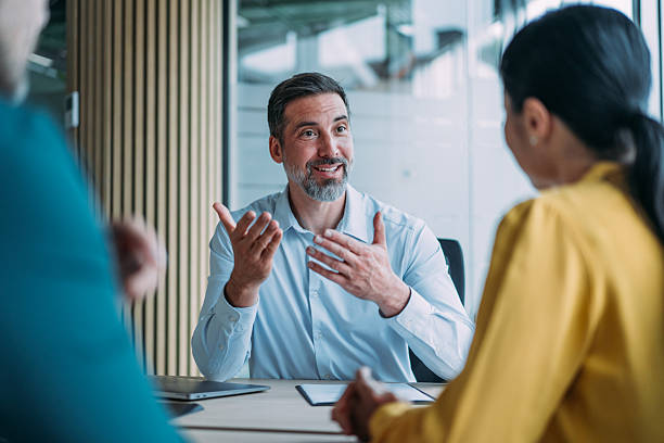 istock Group of business persons talking in the office. 2246435286