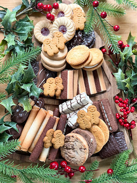 istock Overhead image of asssorted luxury cookies / biscuits with Christmas decorations, gingerbread men, Belgian chocolate cookies, wafers 2246438938