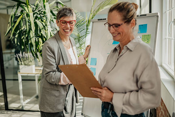 istock Businesswomen collaborate in a modern office while planning for future success on a sunny day 2246439096
