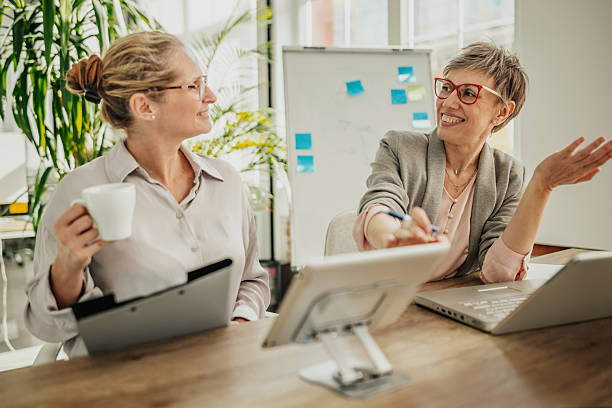 istock Businesswomen collaborating in a bright office space while discussing ideas and planning for success 2246439174