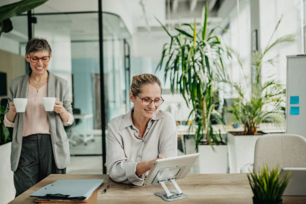 istock Businesswomen collaborating in a modern office environment during a productive workday 2246439266