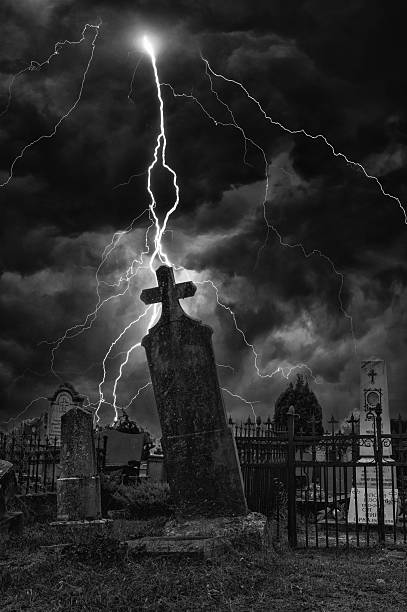 Old spooky cemetery during the storm with lightning.