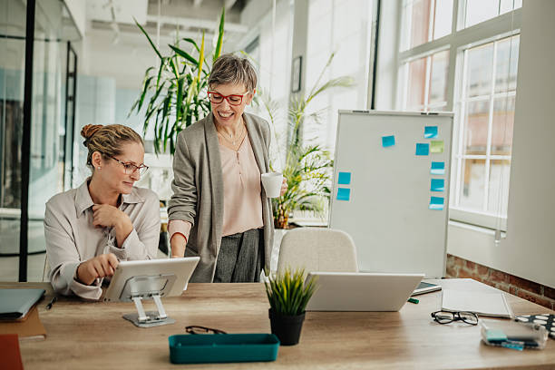 istock Businesswomen collaborating in a modern office setting during a successful workday 2246439976