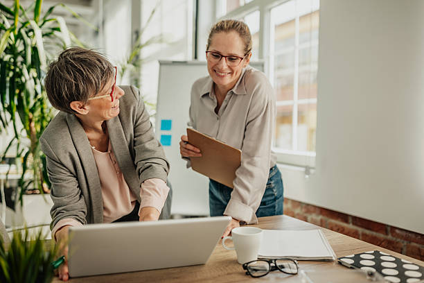 istock Businesswomen collaborating in a modern office setting to achieve success and plan future projects 2246440214