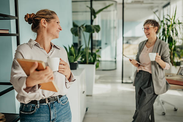 istock Businesswomen engage in collaborative discussion during a productive day at the modern office space 2246441711