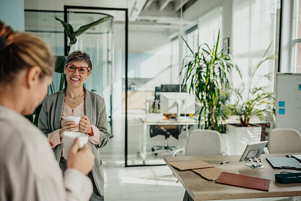istock Businesswomen engage in lively discussion while planning and collaborating in a modern office environment 2246441764