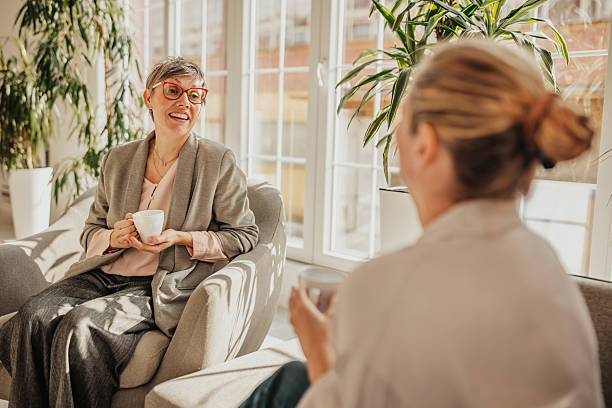 istock Businesswomen engaging in a productive conversation over coffee in a bright office space 2246442163