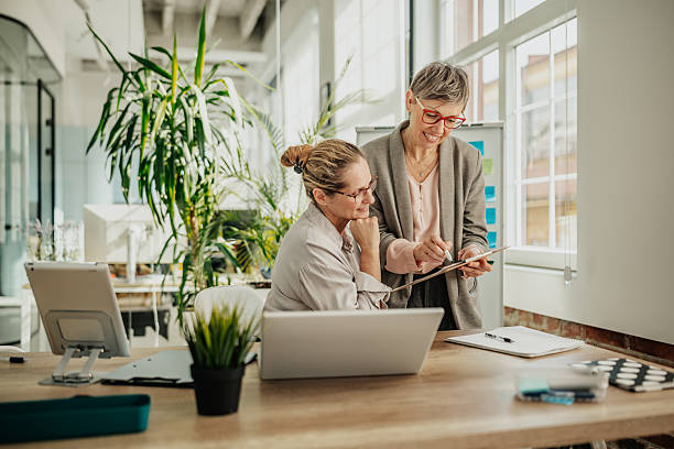 istock Collaborating businesswomen share ideas and plans in a modern office setting during the day 2246442391