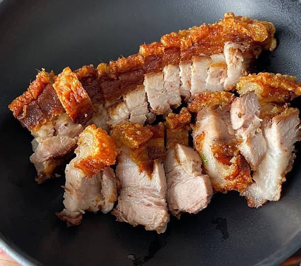 istock Close-up of Crispy Pork Belly on Black Plate 2246443630
